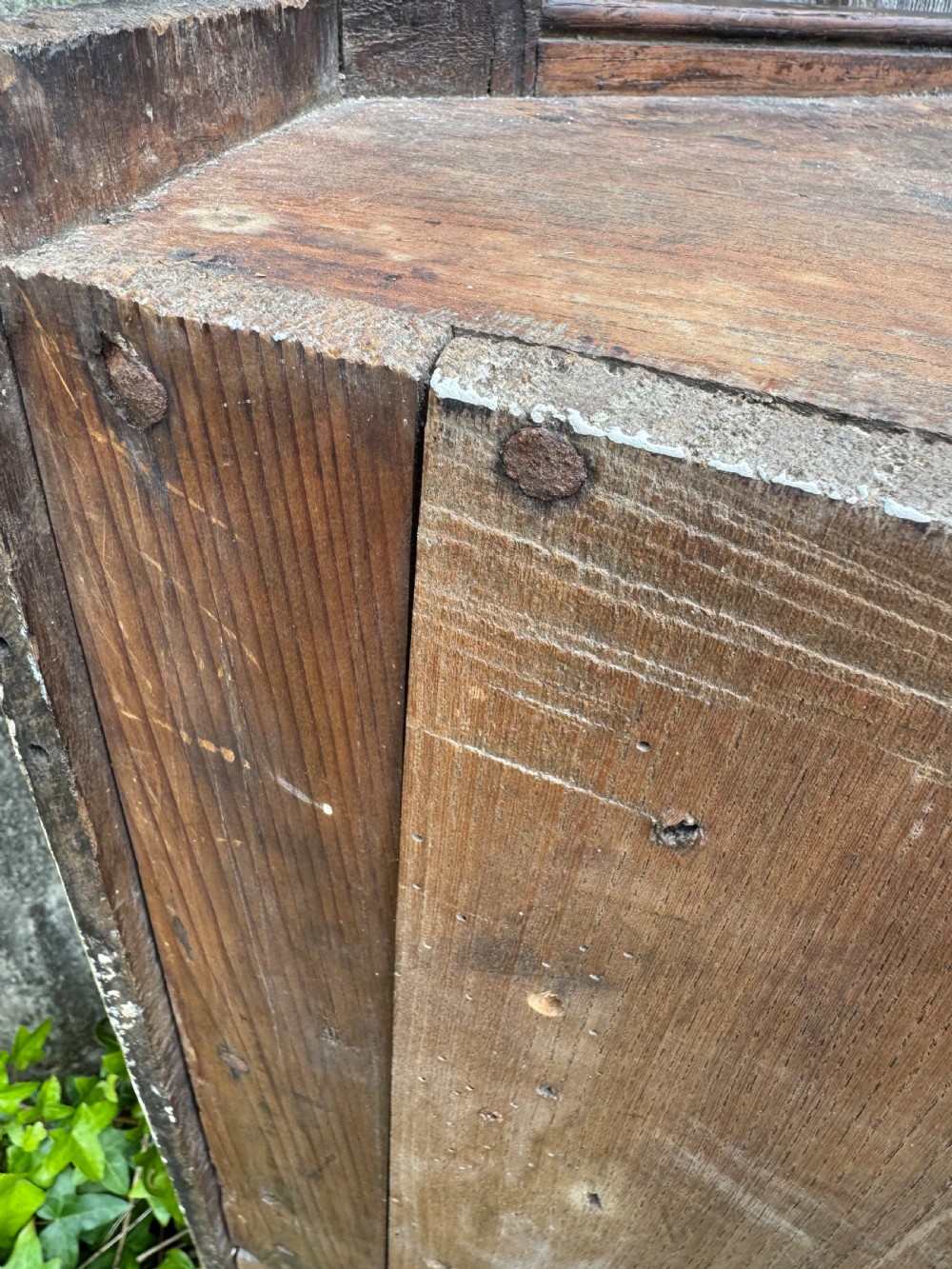 An antique dark oak provincial cupboard featuring canted sides, a single panelled door, a wooden knob, and an iron keyhole escutcheon. View XVIII