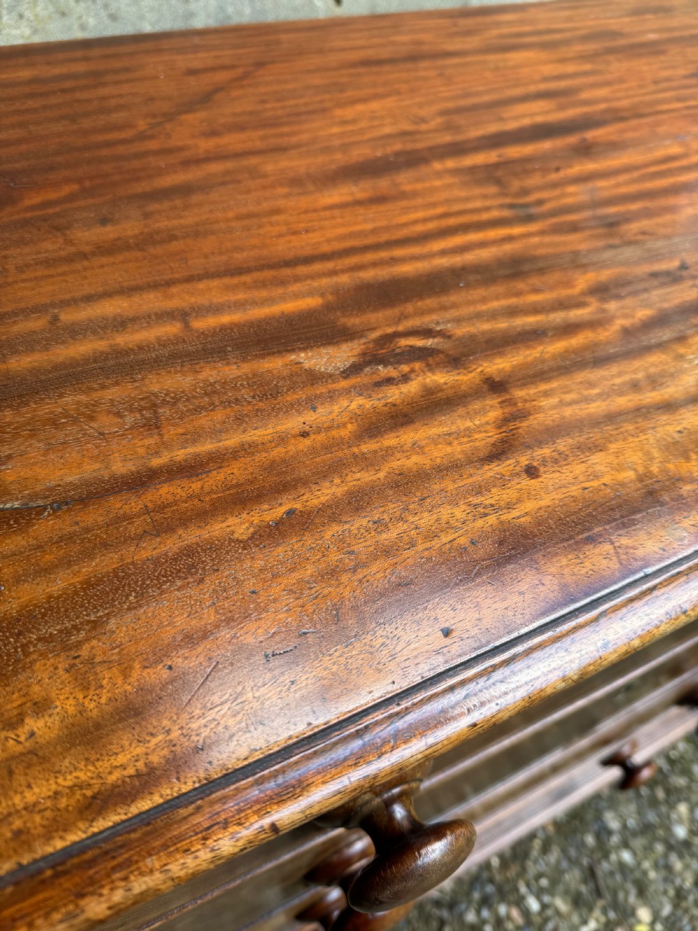A Georgian mahogany chest featuring four graduated drawers with turned wooden knobs, keyhole escutcheons, and classic bracket feet. View XI