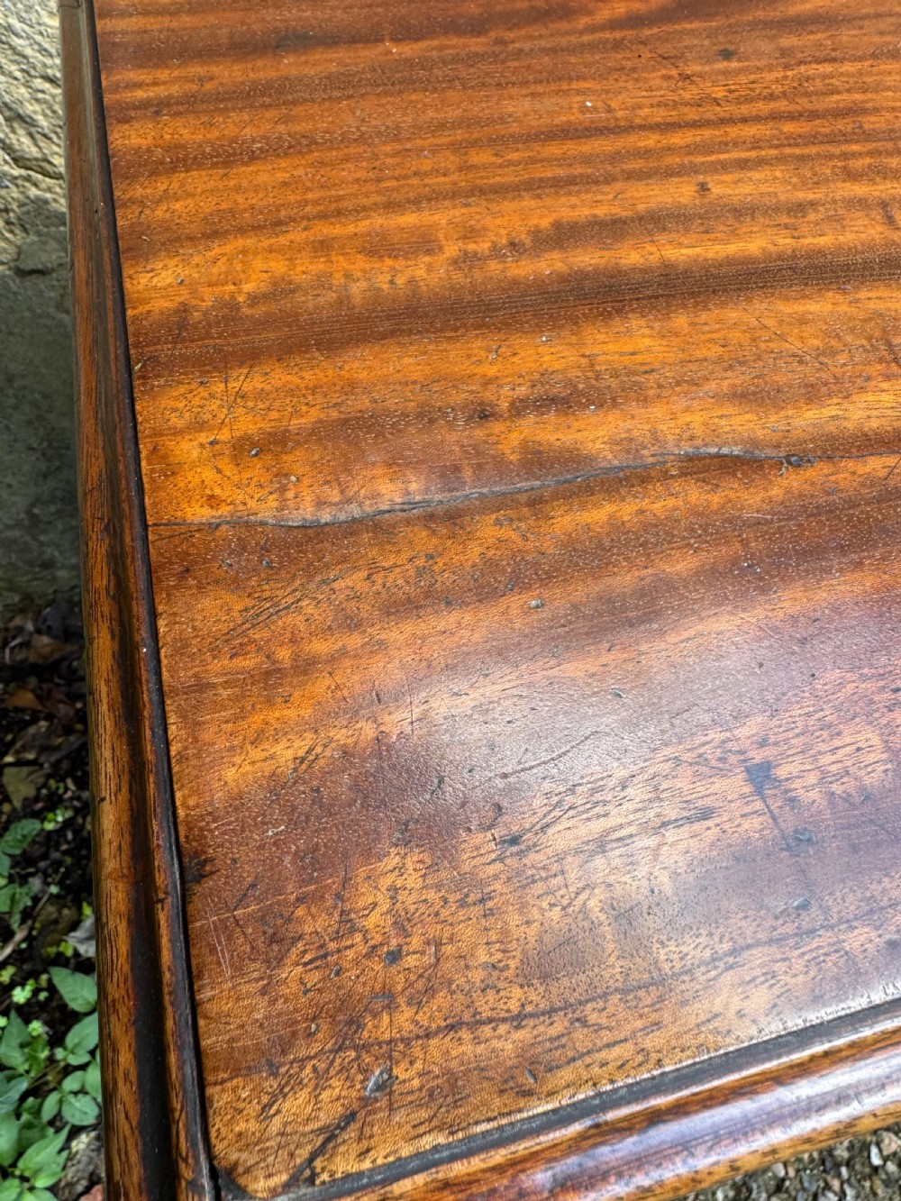 A Georgian mahogany chest featuring four graduated drawers with turned wooden knobs, keyhole escutcheons, and classic bracket feet. View XII