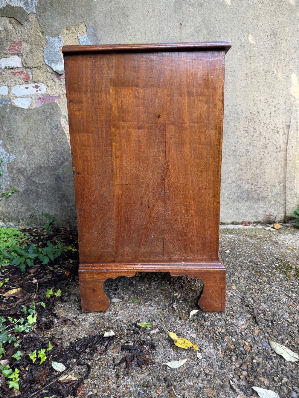 A Georgian mahogany chest featuring four graduated drawers with turned wooden knobs, keyhole escutcheons, and classic bracket feet. View XVIII