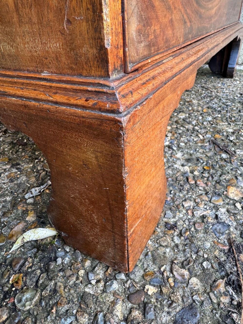 A Georgian mahogany chest featuring four graduated drawers with turned wooden knobs, keyhole escutcheons, and classic bracket feet. View XIX