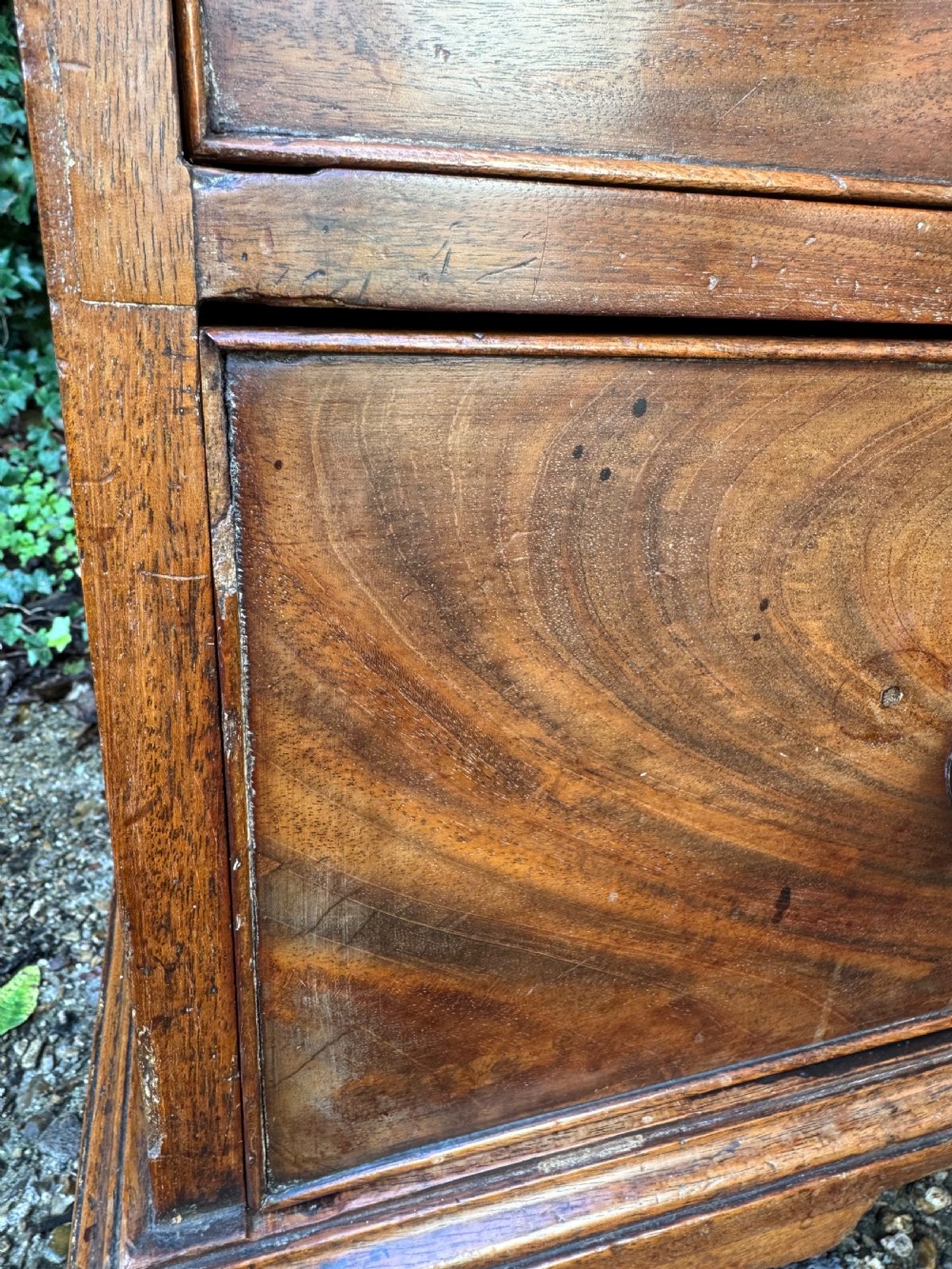 A Georgian mahogany chest featuring four graduated drawers with turned wooden knobs, keyhole escutcheons, and classic bracket feet. View XX