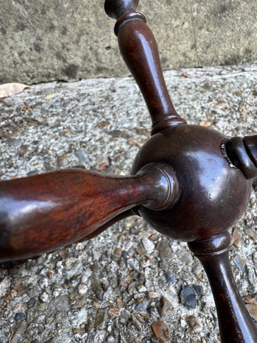 A dark turned wooden cat stand featuring six turned spindle legs radiating from a central sphere. View IV