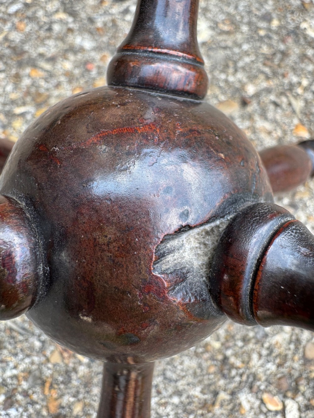 A dark turned wooden cat stand featuring six turned spindle legs radiating from a central sphere. View VI