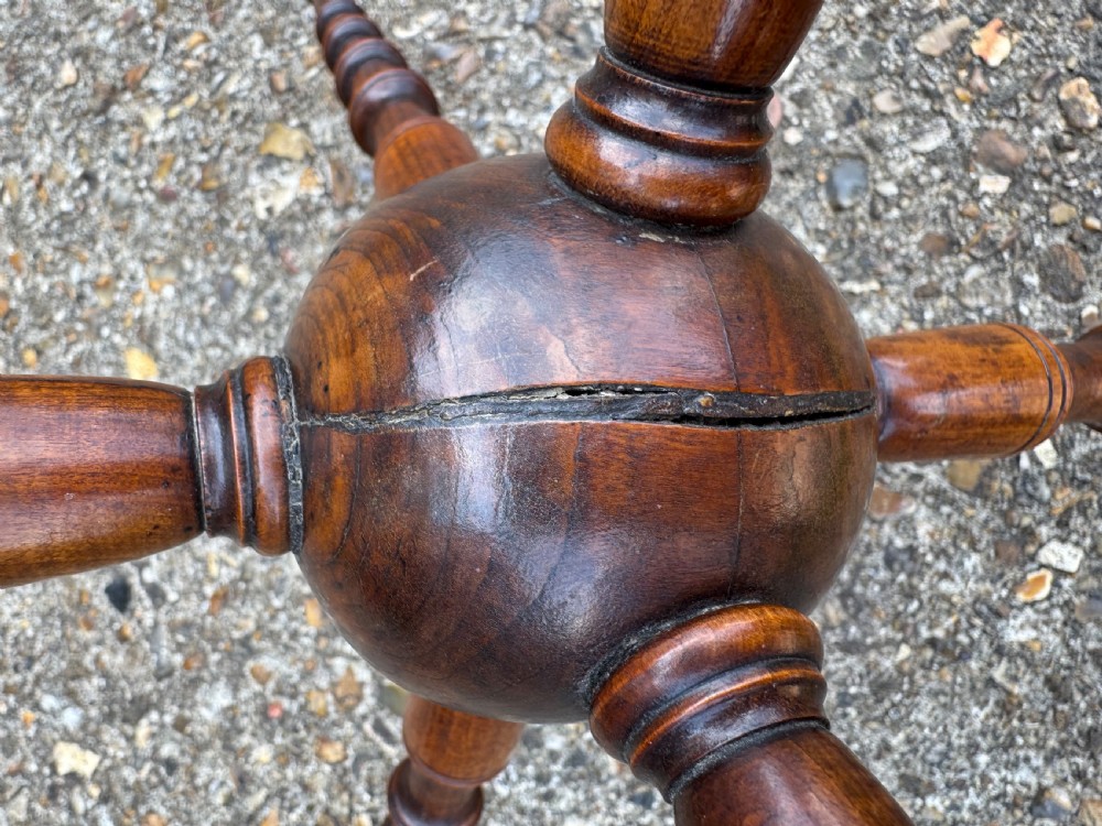 A dark turned wood six-spoked cat stand featuring bobbin-style spindle legs radiating from a central spherical hub. View IV