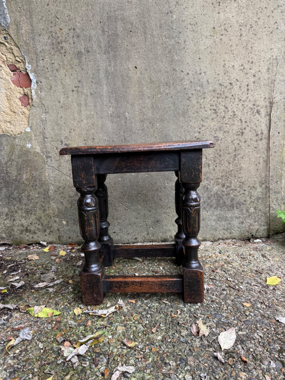A dark oak joint stool featuring turned baluster legs, lower perimeter stretchers, and a flat rectangular top. View III