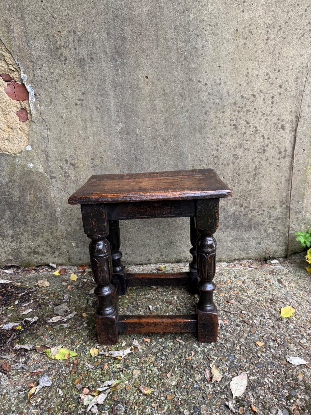A dark oak joint stool featuring turned baluster legs, lower perimeter stretchers, and a flat rectangular top. View IV
