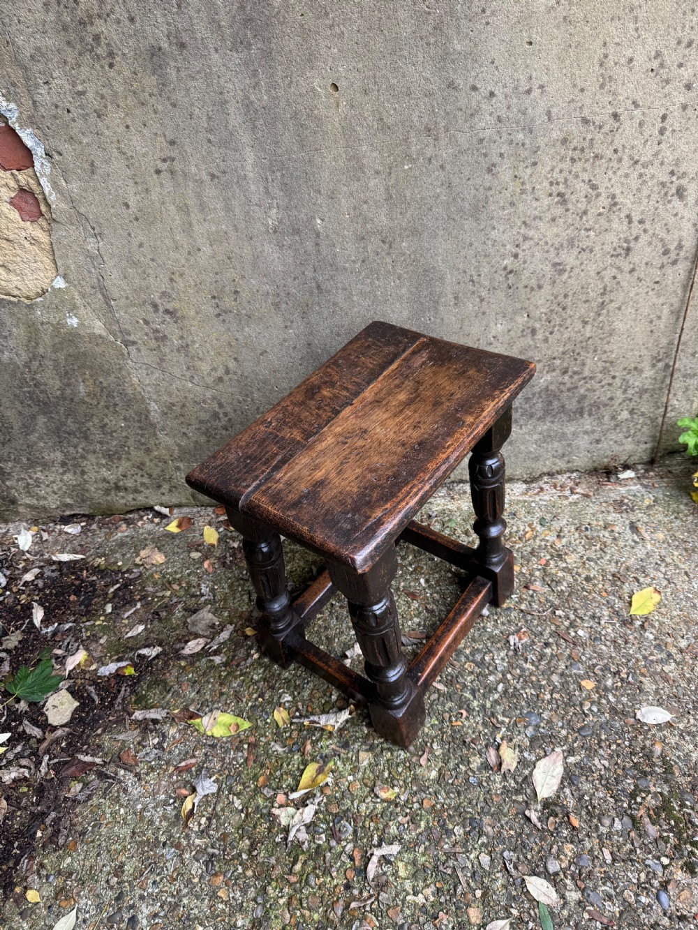 A dark oak joint stool featuring turned baluster legs, lower perimeter stretchers, and a flat rectangular top. View VIII