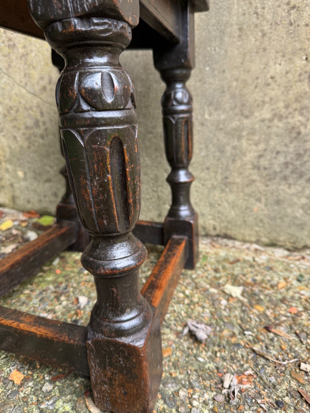 A dark oak joint stool featuring turned baluster legs, lower perimeter stretchers, and a flat rectangular top. View XIII
