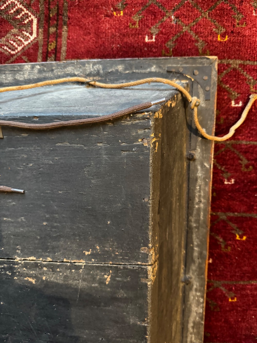 A framed shadow box diorama depicting a three-masted sailing ship on a painted plaster sea beside a rocky cliff and lighthouse. View XII