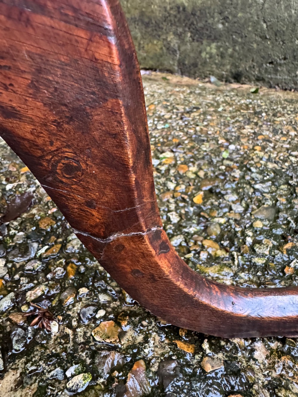 An antique dark oak circular tripod table with a turned central stem, three pad-foot legs, and a tilt-top mechanism. View XVII
