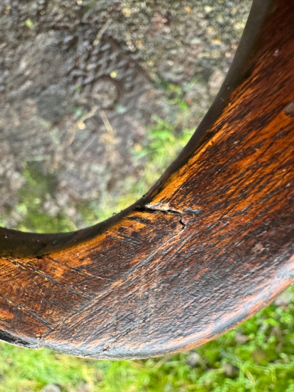 An antique dark oak circular tripod table with a turned central stem, three pad-foot legs, and a tilt-top mechanism. View XXI