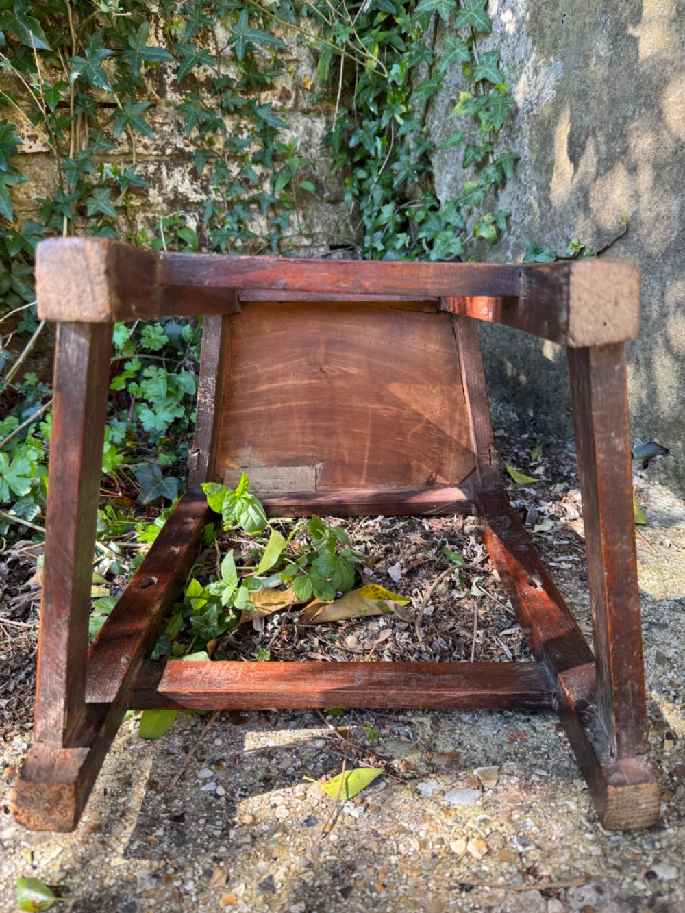 A dark brown Georgian wooden high chair with a central splat back, shaped armrests, square legs, and low wooden stretchers. View IX