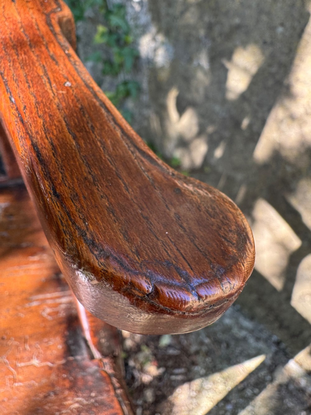 A dark brown Georgian wooden high chair with a central splat back, shaped armrests, square legs, and low wooden stretchers. View XI