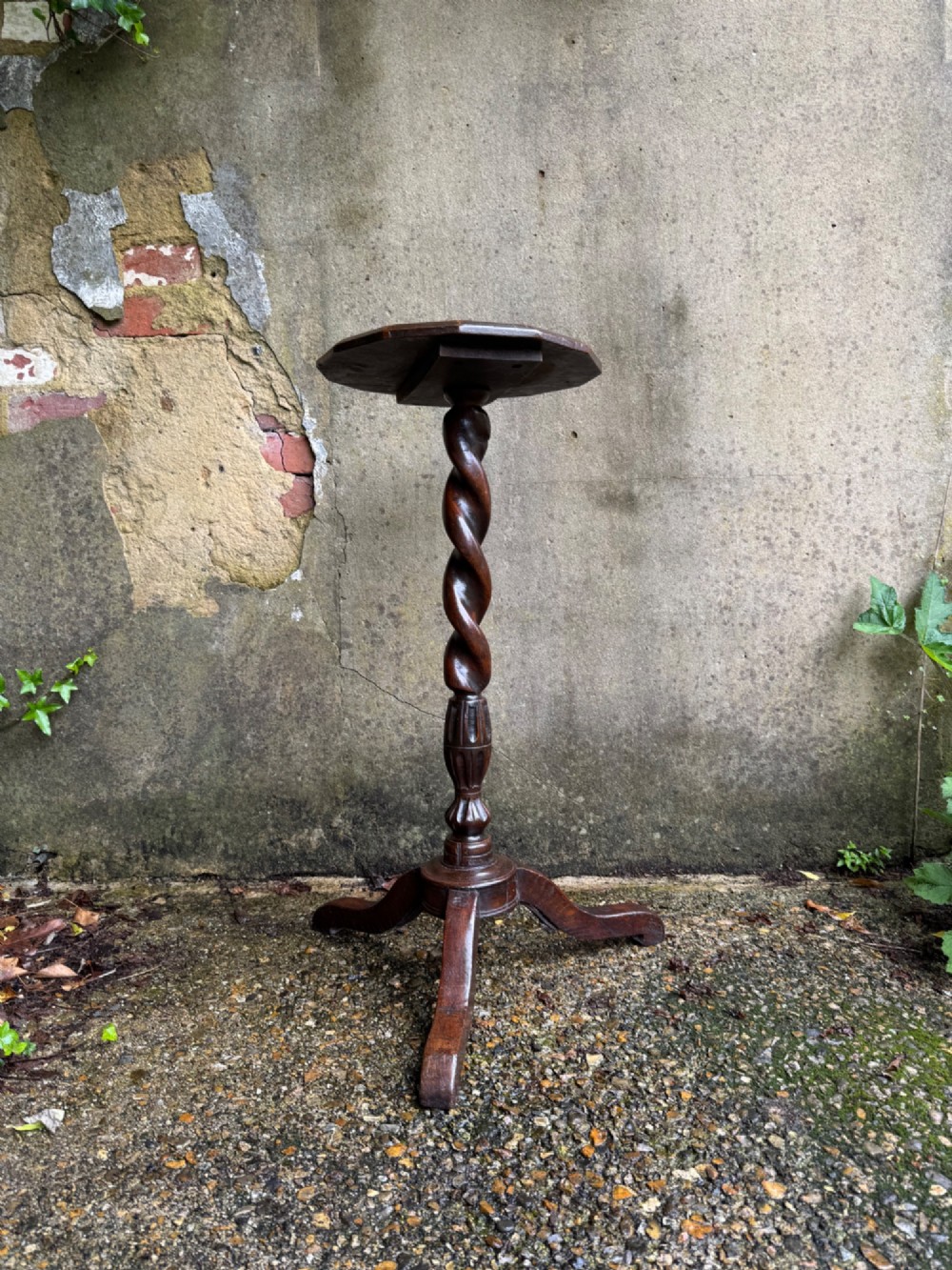 A tall dark oak side table featuring a circular top, a single barley twist column, and three splayed tripod legs. View II
