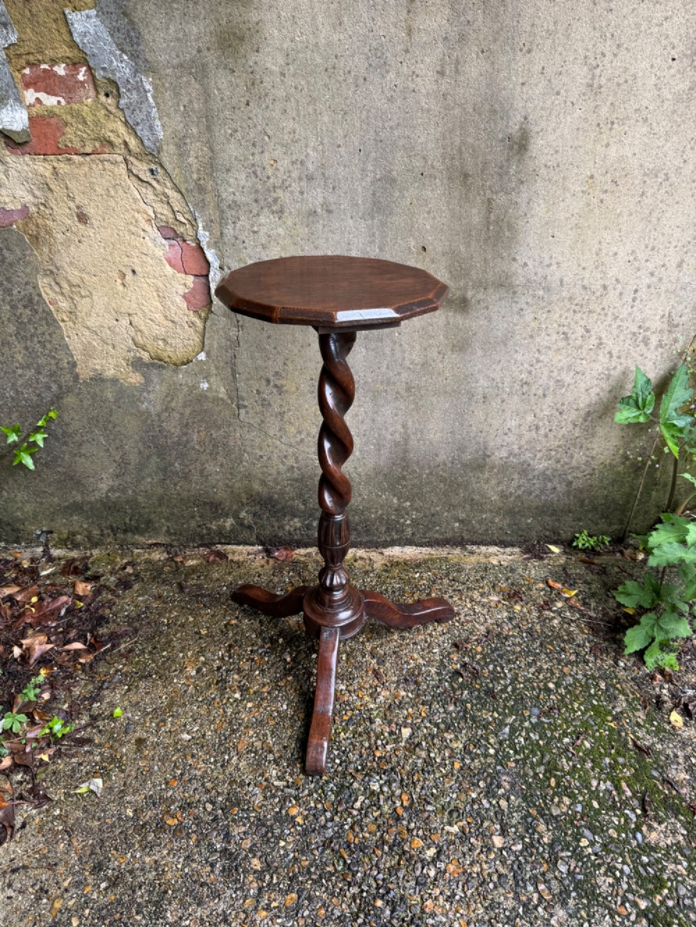 A tall dark oak side table featuring a circular top, a single barley twist column, and three splayed tripod legs. View III