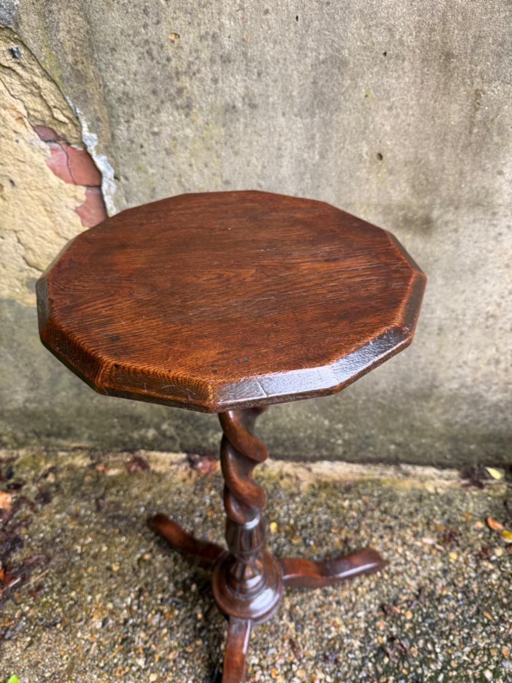A tall dark oak side table featuring a circular top, a single barley twist column, and three splayed tripod legs. View IV