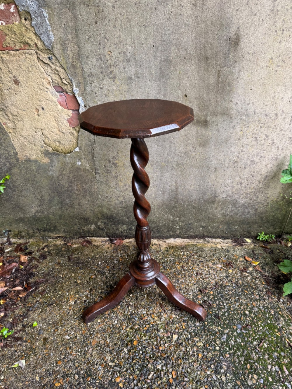 A tall dark oak side table featuring a circular top, a single barley twist column, and three splayed tripod legs. View XI