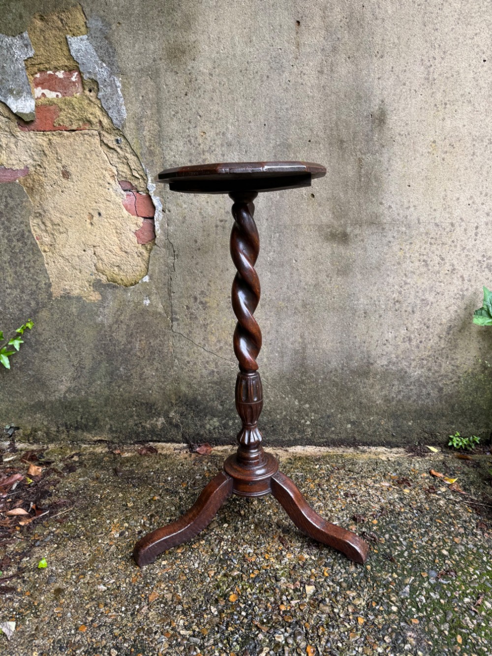 A tall dark oak side table featuring a circular top, a single barley twist column, and three splayed tripod legs. View XV
