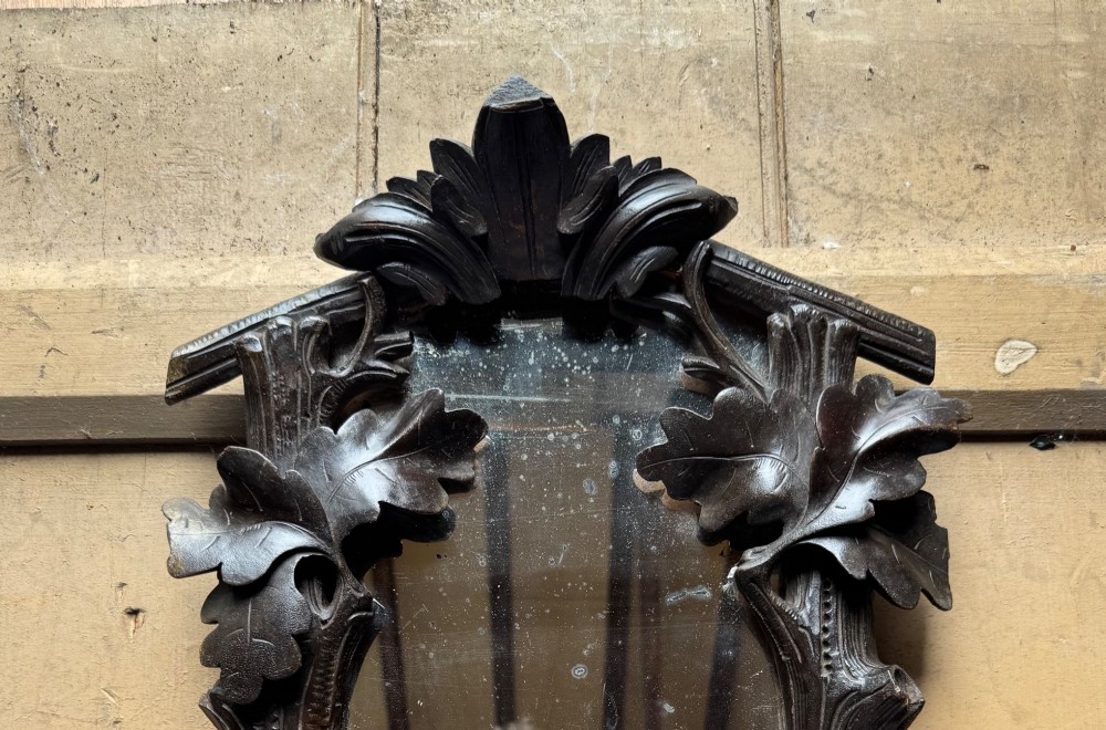 A dark hand-carved wooden wall mirror featuring a fox sculpted at the base surrounded by carved oak leaves and branches. View IV