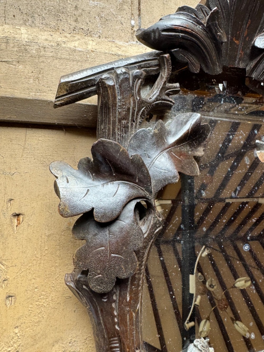 A dark hand-carved wooden wall mirror featuring a fox sculpted at the base surrounded by carved oak leaves and branches. View VII