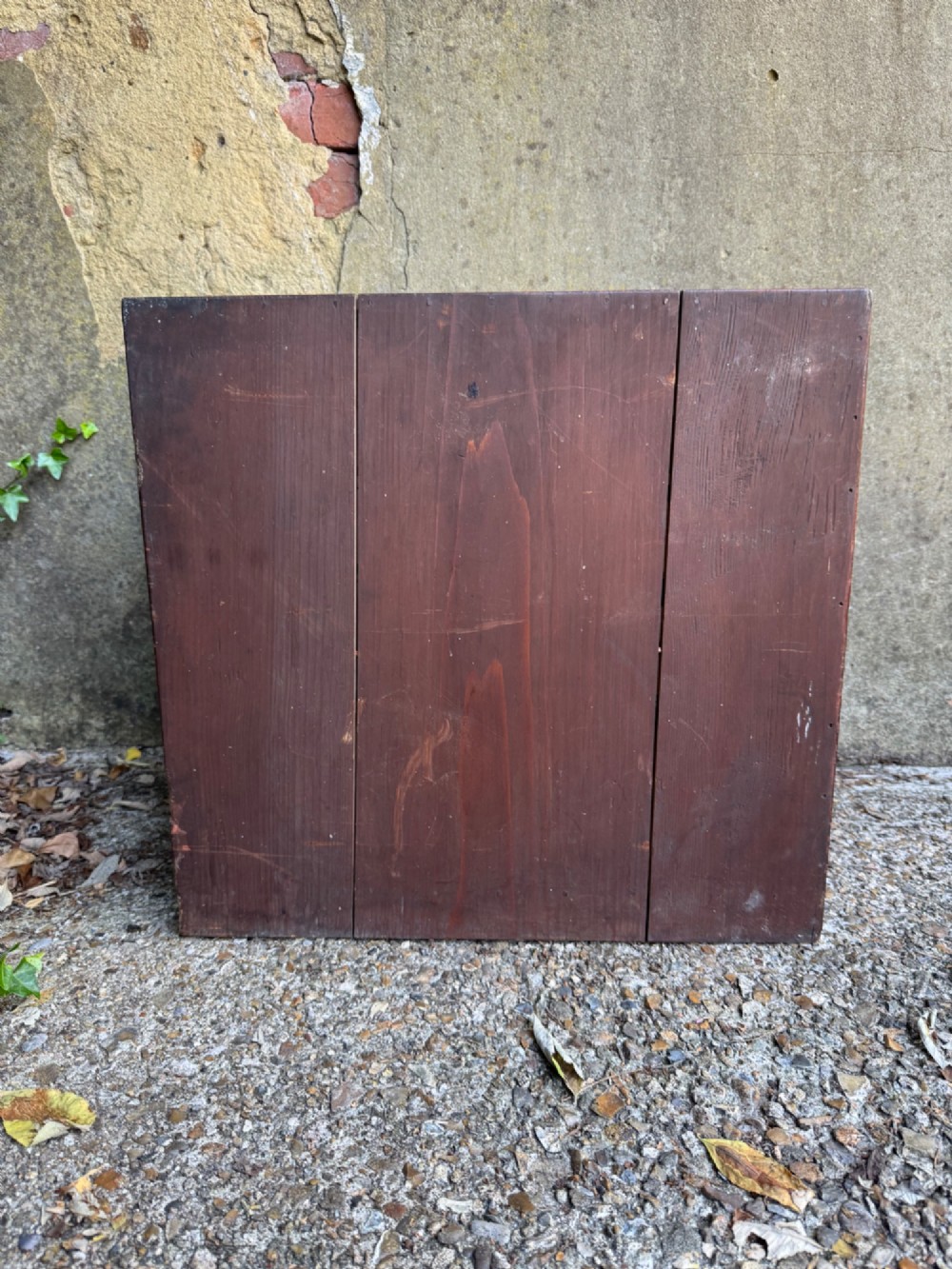 A reddish brown lacquered Japanese wooden tansu chest featuring iron corner plates, circular lock fittings, side carrying handles, and multiple graduated drawers. View XIV