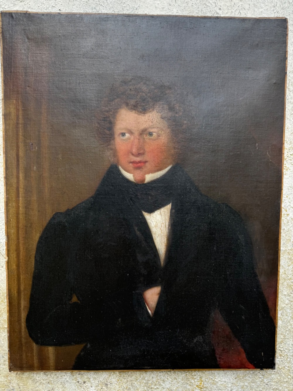 An unframed antique oil painting on canvas depicting a gentleman in a high black cravat and coat against a muted brown background. View III