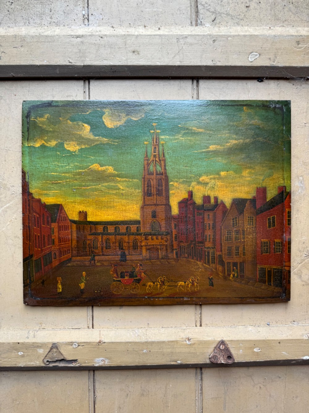 An antique naive oil painting depicting St Nicholas Square in Newcastle with horse-drawn carriages and figures set within a dark wooden frame. View III
