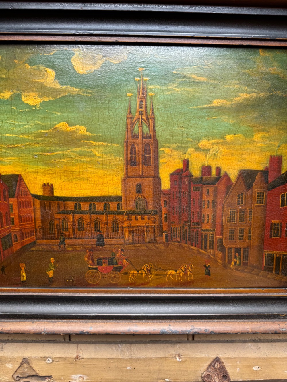 An antique naive oil painting depicting St Nicholas Square in Newcastle with horse-drawn carriages and figures set within a dark wooden frame. View V