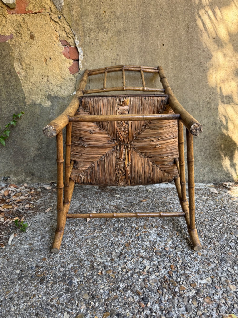 An antique turned wooden armchair with faux-bamboo detailing and a dark woven rush seat. View XIII