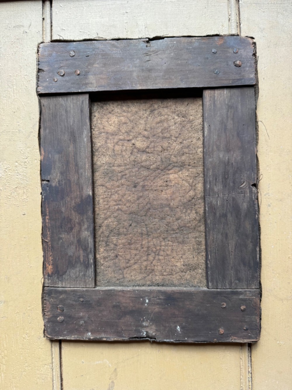 An antique oil painting depicting a standing man with a pipe and his dog in a countryside landscape, housed in a deep silvered moulded frame. View IX