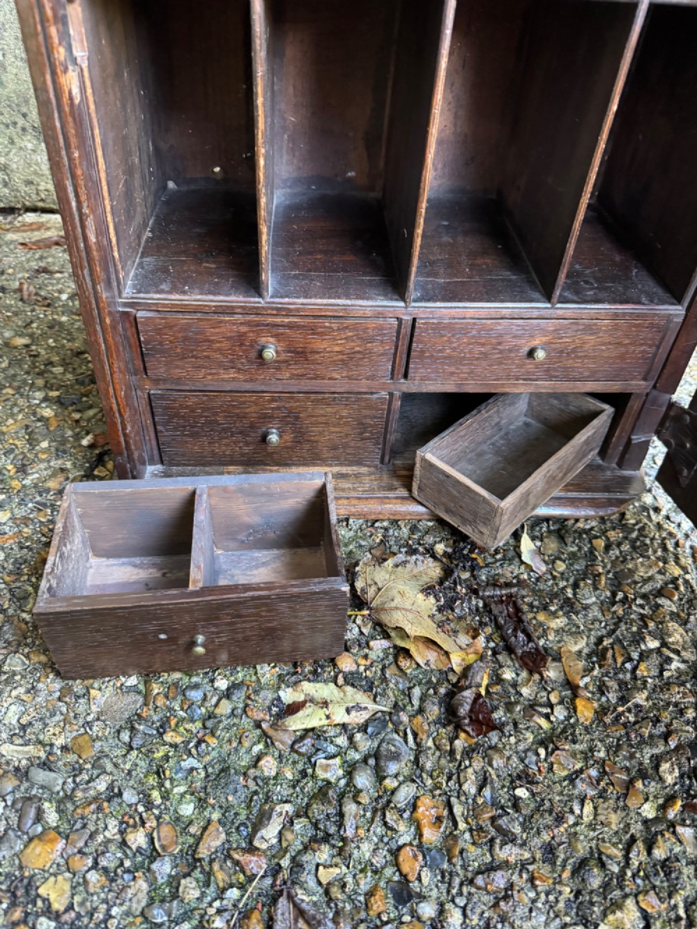 A small dark oak cupboard featuring a single fielded panel door with a brass keyhole escutcheon. View V