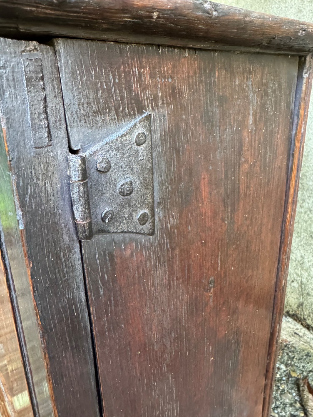 A small dark oak cupboard featuring a single fielded panel door with a brass keyhole escutcheon. View IX
