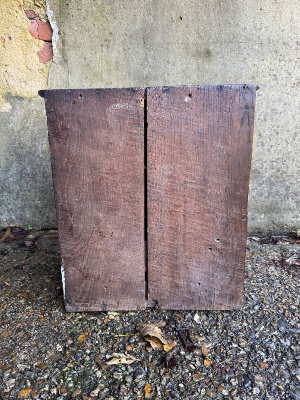 A small dark oak cupboard featuring a single fielded panel door with a brass keyhole escutcheon. View X