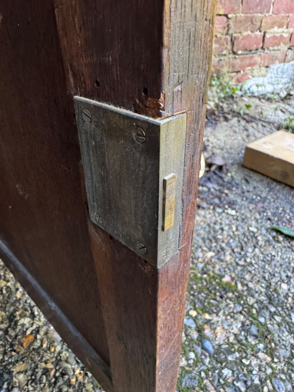 A small dark oak cupboard featuring a single fielded panel door with a brass keyhole escutcheon. View XIV