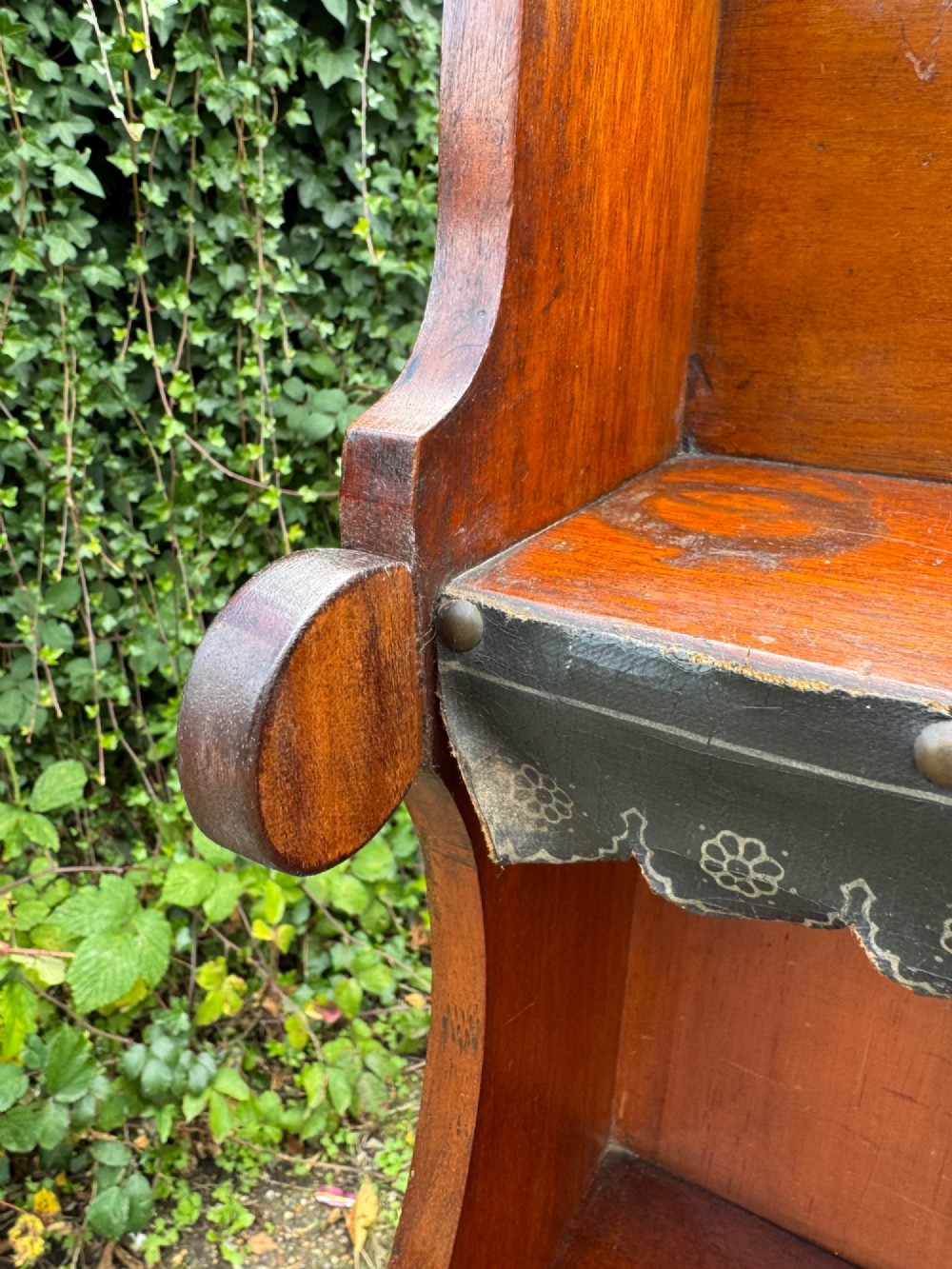 An antique mahogany waterfall bookcase featuring four open graduated shelves with dark trim above two lower drawers with turned wood knobs. View IX