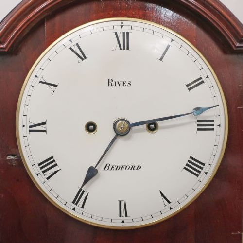 fig 2. A Regency mahogany bracket clock featuring brass mounts, a top handle, fishscale brass side frets, and a circular white dial signed Rives Bedford.