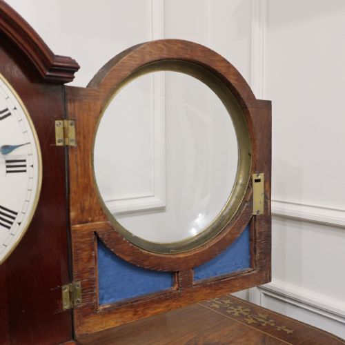 fig 3. A Regency mahogany bracket clock featuring brass mounts, a top handle, fishscale brass side frets, and a circular white dial signed Rives Bedford.