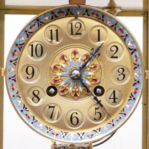 fig 2. An antique French four-glass mantel clock featuring green onyx bases, champleve enamel columns, and a visible brass movement.