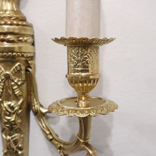 fig 2. A pair of French Louis XVI style gilt bronze twin arm wall lights featuring classical urn finials and ribbon relief decorations.