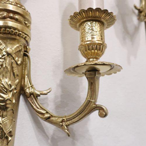 fig 3. A pair of French Louis XVI style gilt bronze twin arm wall lights featuring classical urn finials and ribbon relief decorations.