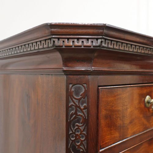 fig 4. A Georgian Chippendale period mahogany chest on chest featuring two upper short drawers over five long drawers with brass swan-neck handles and carved bracket feet.
