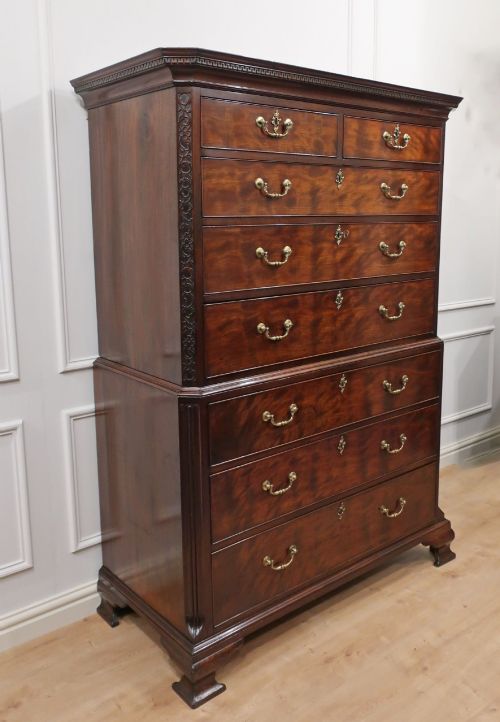 fig 5. A Georgian Chippendale period mahogany chest on chest featuring two upper short drawers over five long drawers with brass swan-neck handles and carved bracket feet.