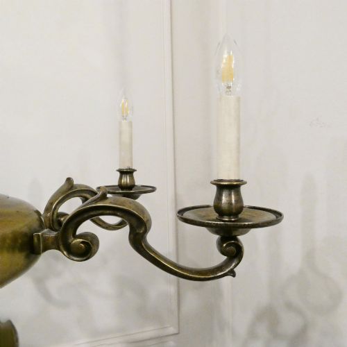 fig 3. An Edwardian six-light aged brass chandelier featuring a central turned baluster shaft, scrolled arms, and candle sleeves.