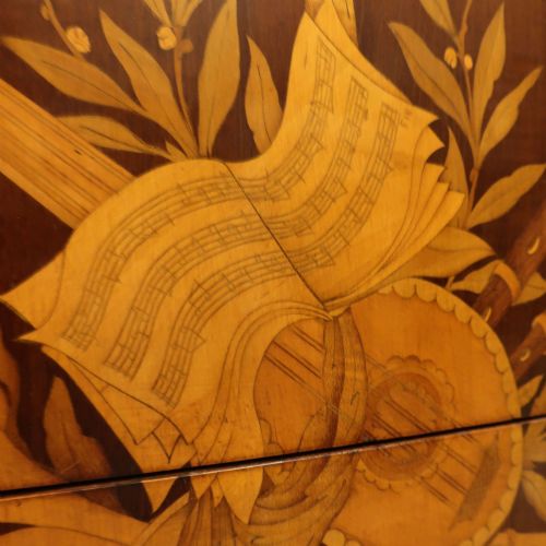 fig 2. A French Louis XVI style marquetry chest of drawers featuring inlaid central medallion motifs, gilded bronze handles, tapered legs, and a fitted marble top.