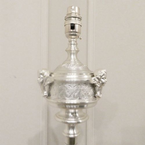 fig 1. An early 20th-century silver-plated standard lamp featuring a turned column, cast base, and a cream scalloped lampshade with fringe detailing.