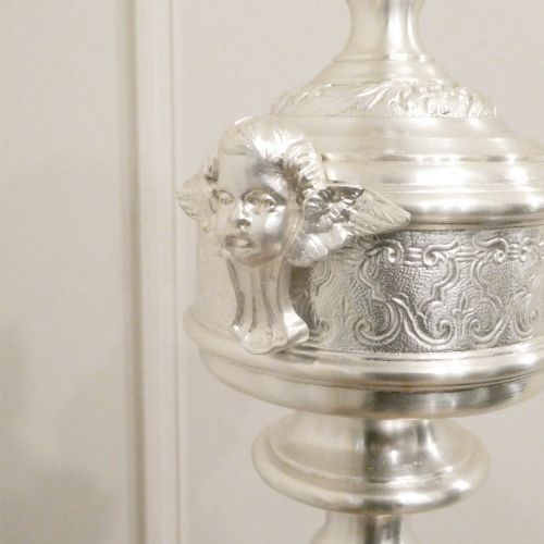 fig 2. An early 20th-century silver-plated standard lamp featuring a turned column, cast base, and a cream scalloped lampshade with fringe detailing.