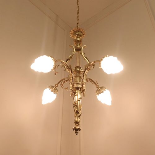 fig 3. A French Neoclassical style gilt bronze chandelier featuring a central lyre-shaped stem and two outward-curving arms with frosted glass shades.