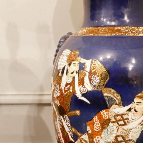 fig 2. A pair of cobalt blue Japanese Satsuma porcelain table lamps decorated with gilded hand-painted figures and fitted with brass mountings and a cream pleated shade.