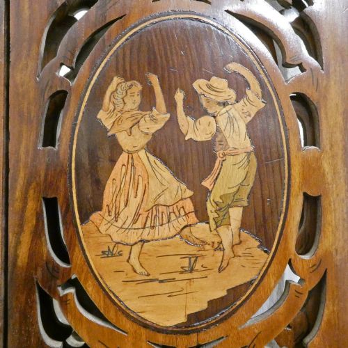 fig 3. A fretted walnut triptych dressing table mirror featuring central oval glass plates surrounded by openwork carved scroll patterns and inlaid timber panels.